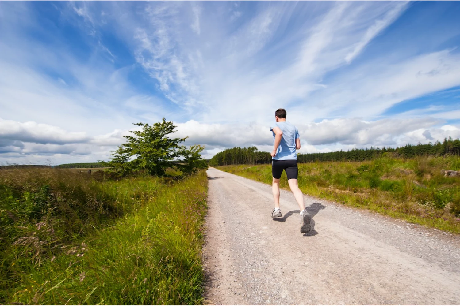 a man running on a dirt road in the country to steward his body and stay healthy