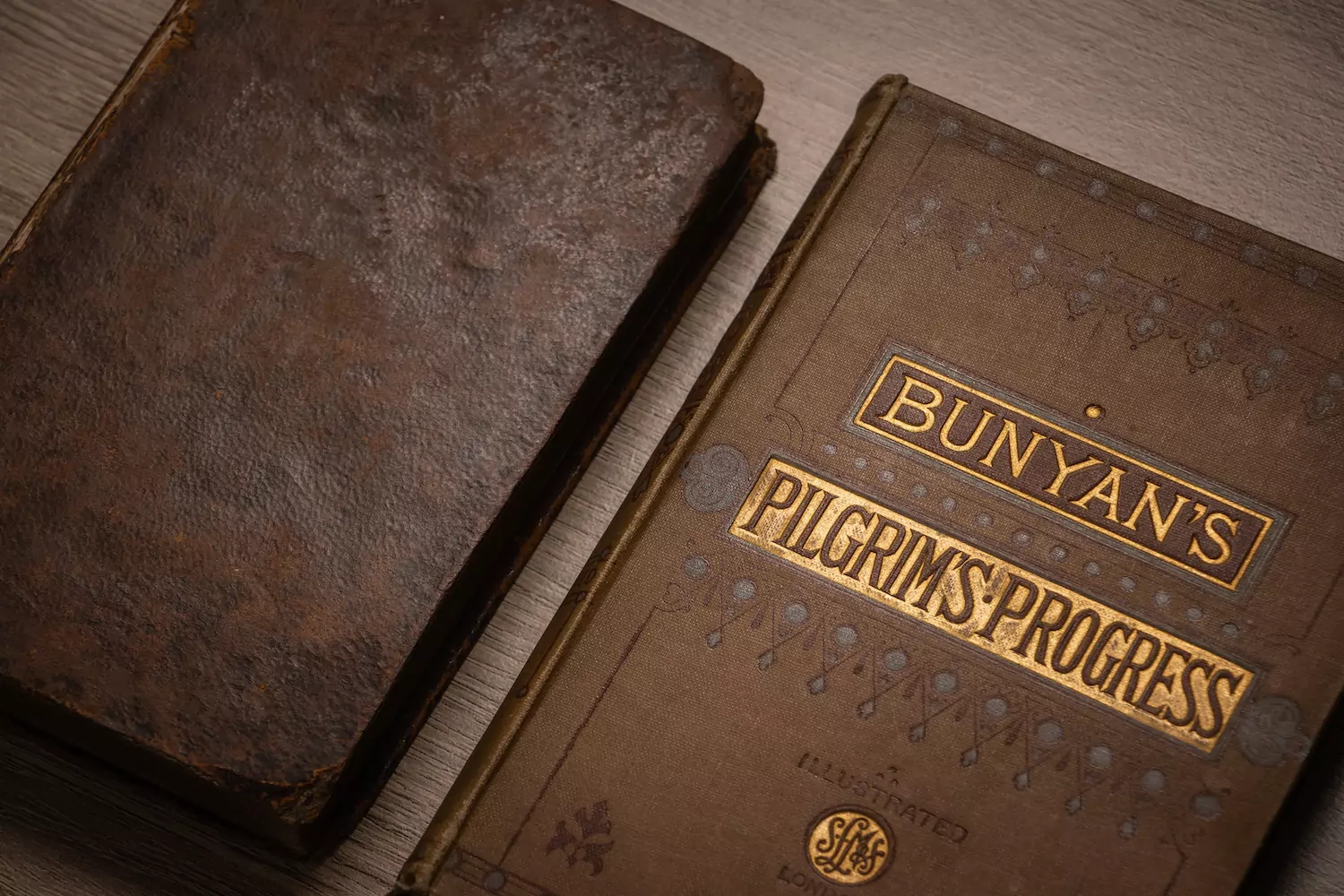 close-up of a copy of Bunyan's "Pilgrim's Progress" and an old leather Bible