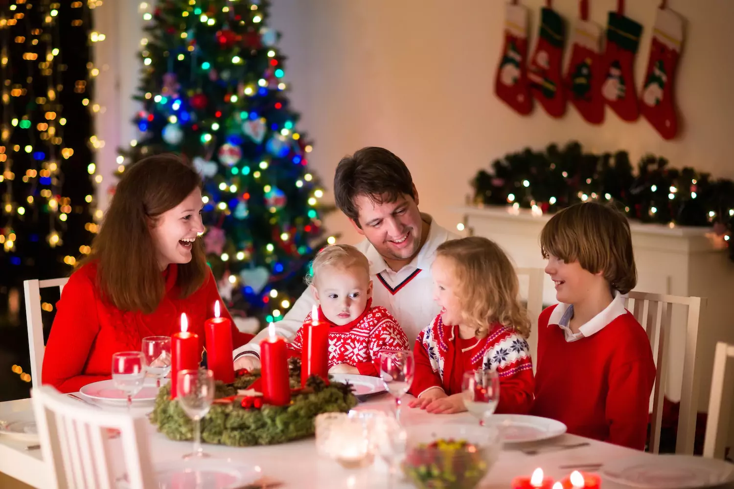 A family sits around the dinner table reading about hope, the third Christmas virtue from our family advent devotional